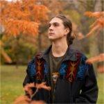 GVSU senior Simon Baker poses for a portrait outdoors.